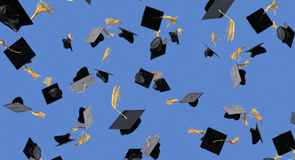 A group of graduates throwing their hats in the air.